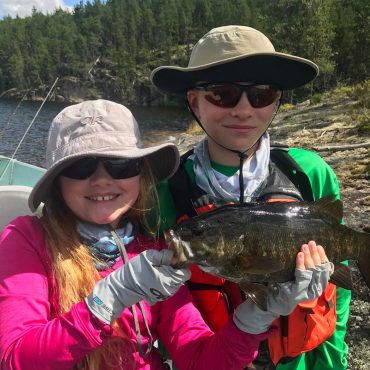 Boy And Girl Holding A Smallmouth Bass