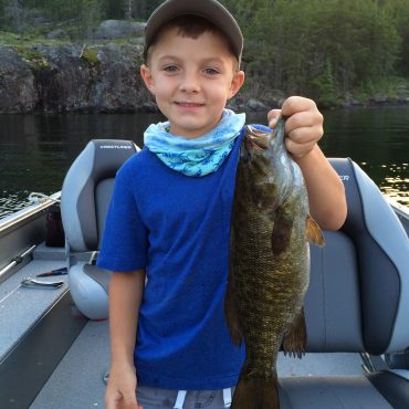 Little Boy Holding A Smallmouth Bass