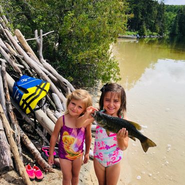 Little Girls Holding A Fish